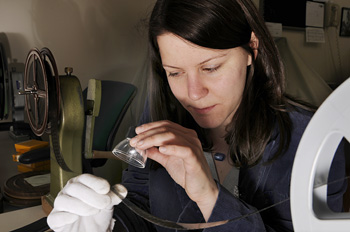 Examining motion picture film through a
loupe.